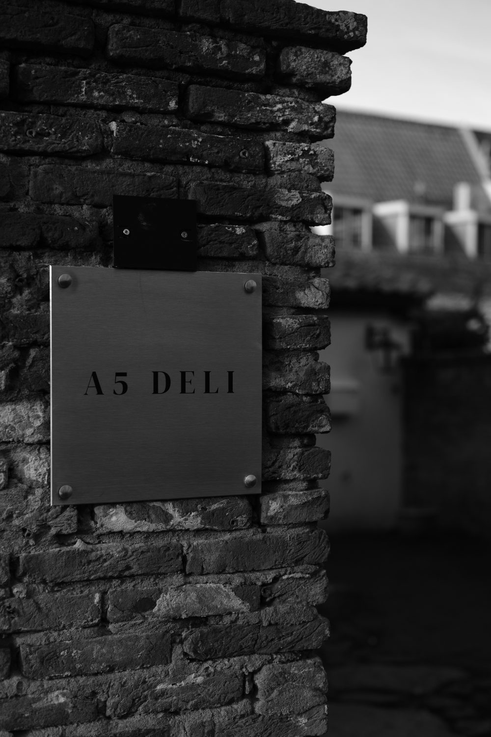 Brushed stainless steel plaque on a heritage brick wall