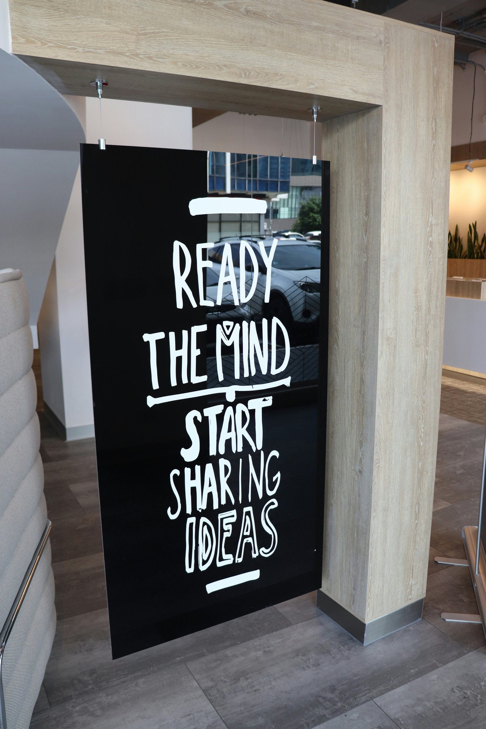 Hand-painted hanging interior signage in a contemporary creative workspace