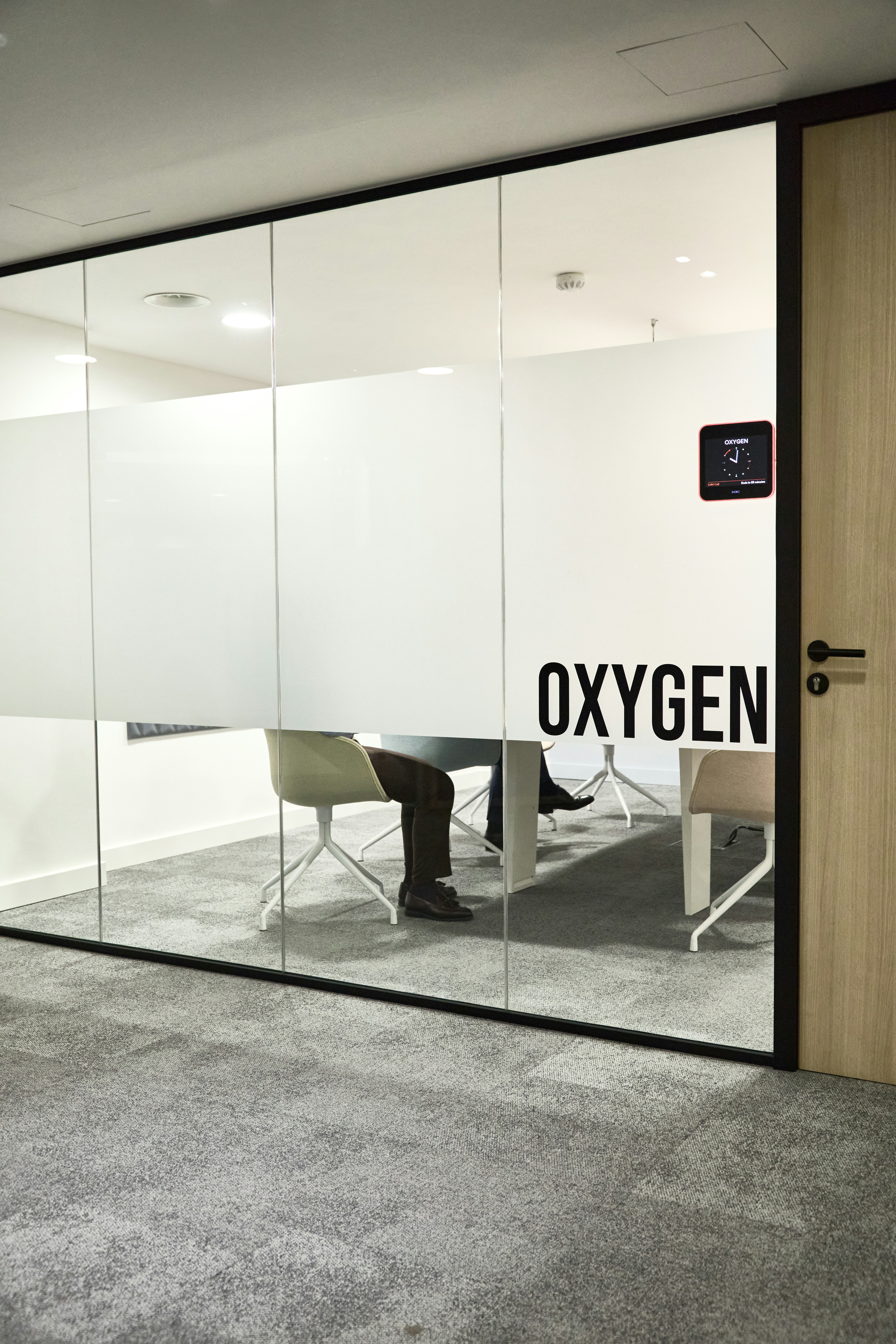 Oxygen — illuminated wayfinding signs in a modern corporate interior